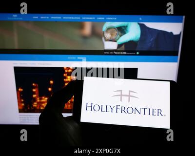 Stuttgart, Germany, 03-01-2022: Person holding cellphone with logo of American petroleum company HollyFrontier Corporation on screen in front of Stock Photo