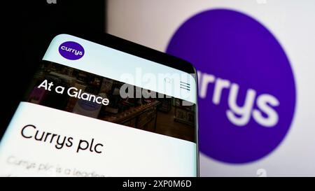 Stuttgart, Germany, 01-09-2022: Mobile phone with website of British electronics retail company Currys plc on screen in front of business logo. Focus Stock Photo