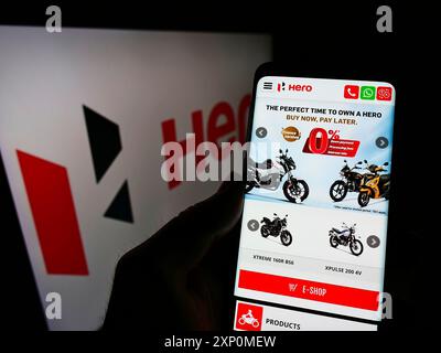 Stuttgart, Germany, 01-06-2022: Person holding cellphone with website of Indian automotive company Hero MotoCorp Limited on screen with logo. Focus Stock Photo