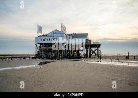 Salt and Silver Restaurant Cafe near St. Peter Ording, North Sea, Germany in the evening with sand of the beautiful beach in front, sunset Stock Photo