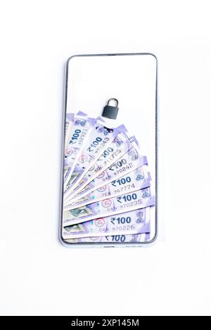 Smart phone and Indian one hundred rupees lock by phone screen isolated on white background Stock Photo