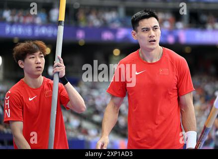 Paris, France. 3rd Aug, 2024. Yao Jie (R) and Zhong Tao of China react before the men's pole vault qualification of Athletics at the Paris 2024 Olympic Games in Paris, France, Aug. 3, 2024. Credit: Song Yanhua/Xinhua/Alamy Live News Stock Photo