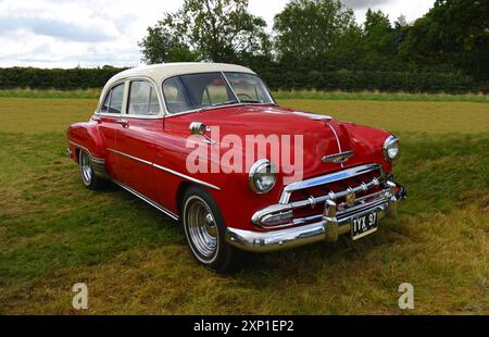 Classic  Chevrolet styline 1952 parked in field. Stock Photo