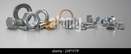 Different types of metal bolts, nuts, screws, hooks and washers. Fasteners and hardware tools on table. Stock Photo