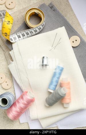 Flat lay composition with different sewing supplies on table Stock Photo