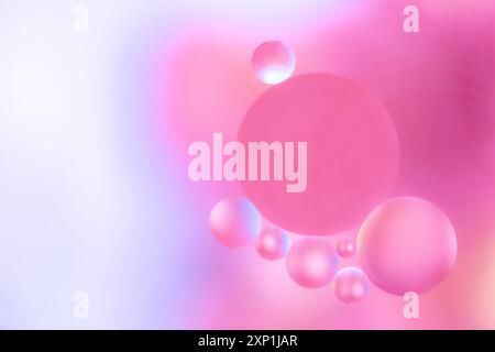 Abstract image with soft pink and purple bubbles of different sizes on a smooth gradient background. dreamy colors and delicate shapes for the present Stock Photo