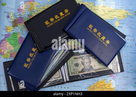 Currency Collectors Album with Banknotes on Map Stock Photo