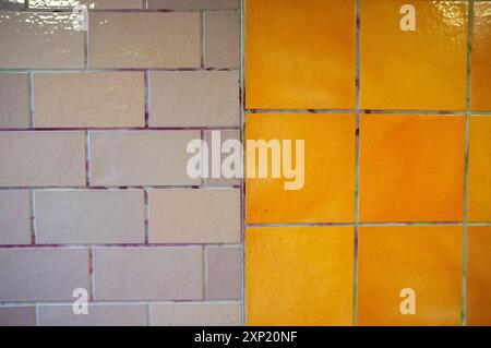 Detailed photo showcasing contrasting beige and orange tiled wall in geometric patterns Stock Photo