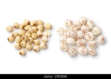 Heap of puffed Lotus seed, Makhana and a heap of dried lotus seed isolated on white background close up Stock Photo