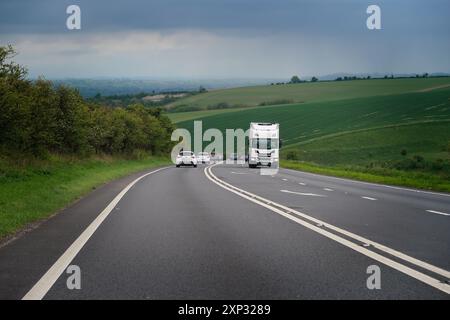 Double white lines on a single carriageway section of the A303 trunk road on a steep hill in West Wiltshire. Stock Photo