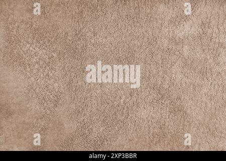 Brown suede leather texture with embossed pattern macro, close up. Structure of fleecy cloth surface, decorative material for upholstery, home decor a Stock Photo