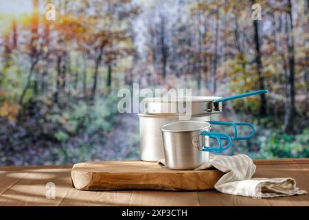 Forest Mess Table Aluminium dishes and mess tin on wooden autumn table and autumn trees ...