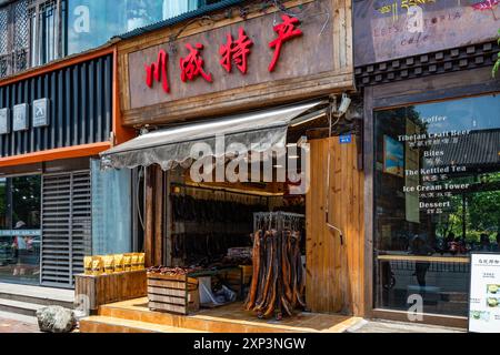 Smoked bacon hanging in front of a store. Sichuan, China. Stock Photo