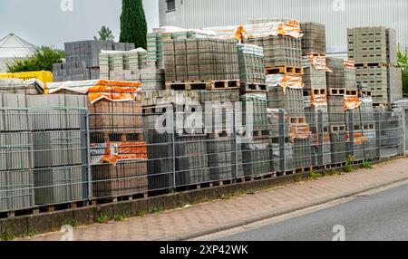 Paving stones on pallets in a warehouse. Construction in the city. Renovation of sidewalks and bike paths. Construction warehouse. Stock Photo