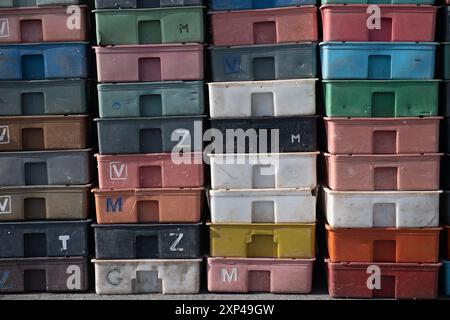 Colorful plastic boxes in grid pattern for efficient warehouse storage Stock Photo