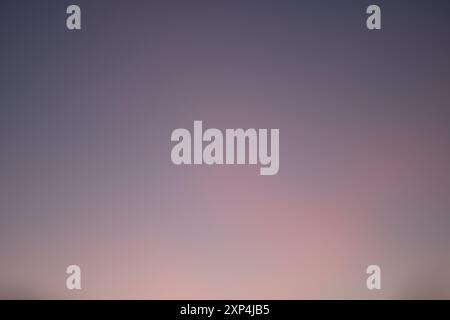The background is purple with a gradient blending brown, violet, blue, magenta, sky, cloud, tints and shades, event, and cumulus Stock Photo