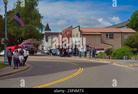 Visitors explore the old town of Ketchikan in a view looking down Mission Street toward St. John's Church. Stock Photo