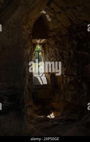 View through a castle window showcasing part of Bodiam Castle’s ...