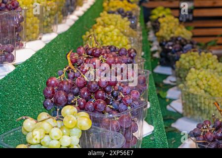 Delicious grapes on the supermarket shelf. Selective focus. Stock Photo