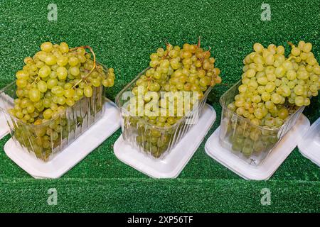 Delicious grapes on the supermarket shelf. Stock Photo