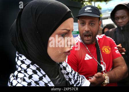 Manchester, England, UK. 3rd Aug, 2024. A young muslim girl who refused to move away from nationalist protesters is spat upon during the demonstration in central Manchester. Following the murder of three children in Stockport over a dozen towns and cities are seeing demonstrations and anti racist counter-demos across the UK. There has been disorder at a number of gatherings. A 17-year-old man has been arrested and charged with their murder (Credit Image: © Martin Pope/ZUMA Press Wire) EDITORIAL USAGE ONLY! Not for Commercial USAGE! Stock Photo