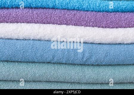 Colorful towels stacked on top of each other. Close up and full of screen. Stock Photo