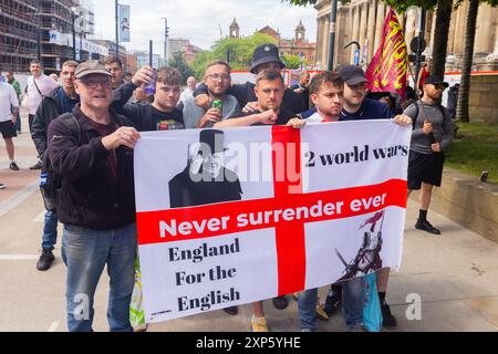 Leeds, UK. 03 AUG, 2024. Demonstrators hold English flag with Winston Churchill and 'England for the English' as protestors on both the left and right of the spectrum gathered in Leeds. A sizeable self-identifying right wing assembly of around 200 people gathered with a counter demo from SUTR, as well as activists from the weekly Pro Palestine march. The right marched through central Leeds briefly and one arrest was noted. Credit Milo Chandler/Alamy Live News Stock Photo