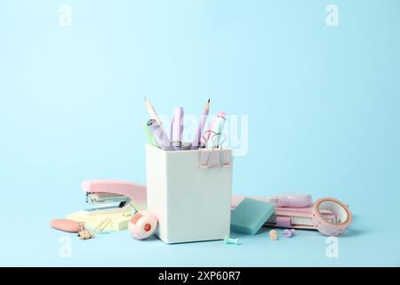Stapler and other stationery on light blue background Stock Photo