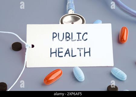 Medical concept. PUBLIC HEALTH words written on a white card on a gray background. Concept photo Stock Photo