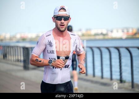 28th July 2024, T100 Triathlon World Series men's race, London Docklands, UK. Sam Laidlow of France on his way to winning the race. Stock Photo