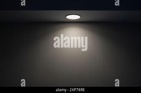Ray of light from round compact lamp in dark room during night time Stock Photo