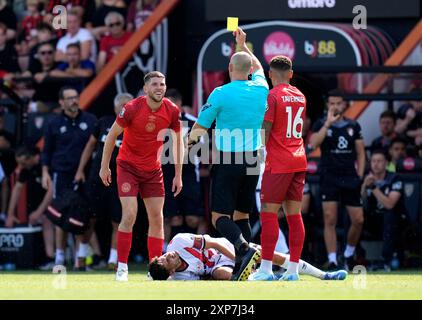 AFC Bournemouth's Ryan Christie (left) is shown a yellow card after a foul on Rayo Vallecano's Alvaro Garcia during the pre-season friendly match at the Vitality Stadium, Bournemouth. Picture date: Sunday August 4, 2024. Stock Photo