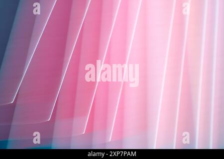 A motion blur effect created by sheets of pink paper that give the appearance of folded fabric. Stock Photo
