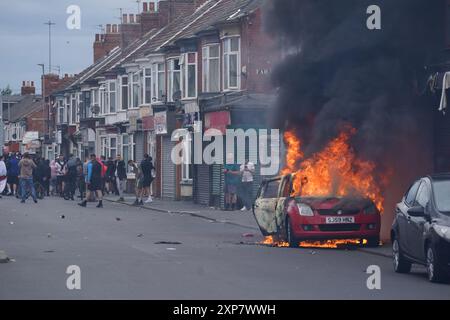 A car burns during an anti-immigration protest in Middlesbrough. Picture date: Sunday August 4, 2024. Stock Photo