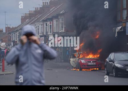 A car burns during an anti-immigration protest in Middlesbrough. Picture date: Sunday August 4, 2024. Stock Photo
