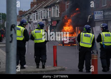 A car burns during an anti-immigration protest in Middlesbrough. Picture date: Sunday August 4, 2024. Stock Photo