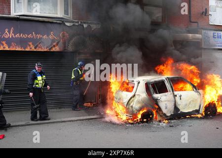 A car burns on Parliament Road, in Middlesbrough, during an anti-immigration protest. Picture date: Sunday August 4, 2024. Stock Photo