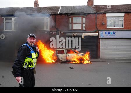 A car burns on Parliament Road, in Middlesbrough, during an anti-immigration protest. Picture date: Sunday August 4, 2024. Stock Photo