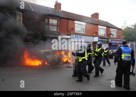 A car burns on Parliament Road, in Middlesbrough, during an anti-immigration protest. Picture date: Sunday August 4, 2024. Stock Photo
