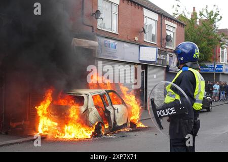 A car burns on Parliament Road, in Middlesbrough, during an anti-immigration protest. Picture date: Sunday August 4, 2024. Stock Photo