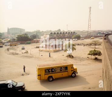 An image depicting a public toilet as part of a landscaping project along the Apapa-Ijora Expressway in Lagos, Nigeria. The scene shows bustling street life, modern structures, and local transport, symbolizing urban development and public sanitation. 2009 Stock Photo