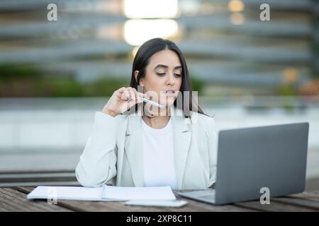 Businesswoman Working on Laptop Outdoors During Daylight Hours Stock Photo
