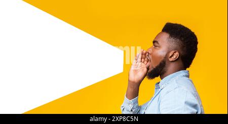 Guy making loud announcement at copy space on yellow background Stock Photo