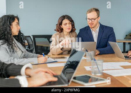 Business Professionals Collaborate on a Project Using Laptops Stock Photo
