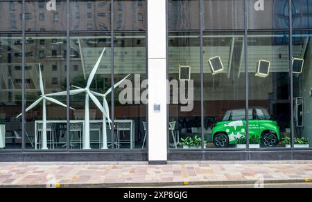 Model wind turbines and Citroen Ami quadricycle electric vehicle with OVO Energy branding in an office window, Scotland, UK, Europe Stock Photo