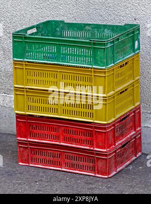 Colorful empty plastic trays stack outside on market place Stock Photo