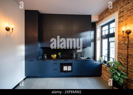 Modern furnished kitchen with household appliances and a dining room ...