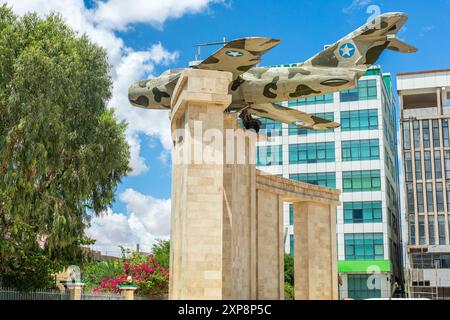 Old war memorial with soviet jet fighter and modern buildings in the  downtown streets of Hargeisa, Somaliland, Somalia Stock Photo