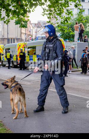 Bristol riot -  Police use police dogs to control and push back Far-right activists during an Enough is Enough protest in Bristol. 03-08-2024 Stock Photo