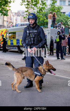 Bristol riot -  Police use police dogs to control and push back Far-right activists during an Enough is Enough protest in Bristol. 03-08-2024 Stock Photo